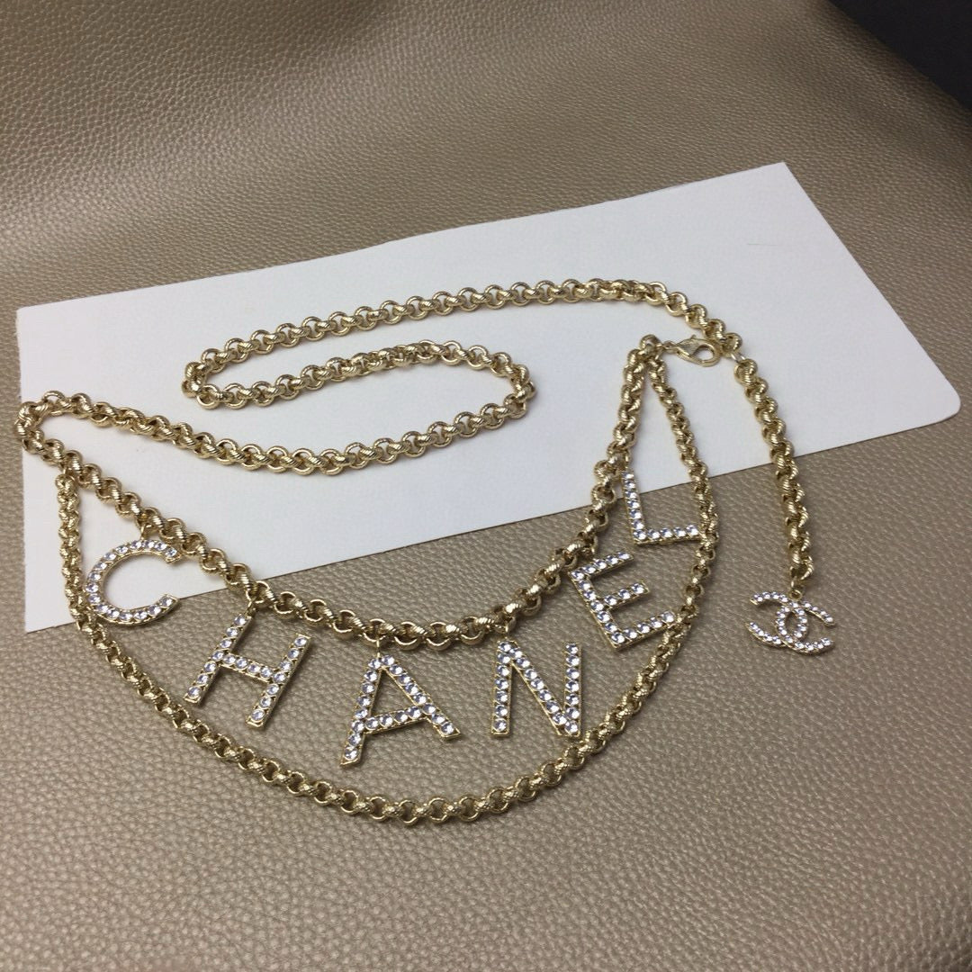 Signature Emblem Jewelry Accessory in Polished Metal-Tone – White Detail front product view