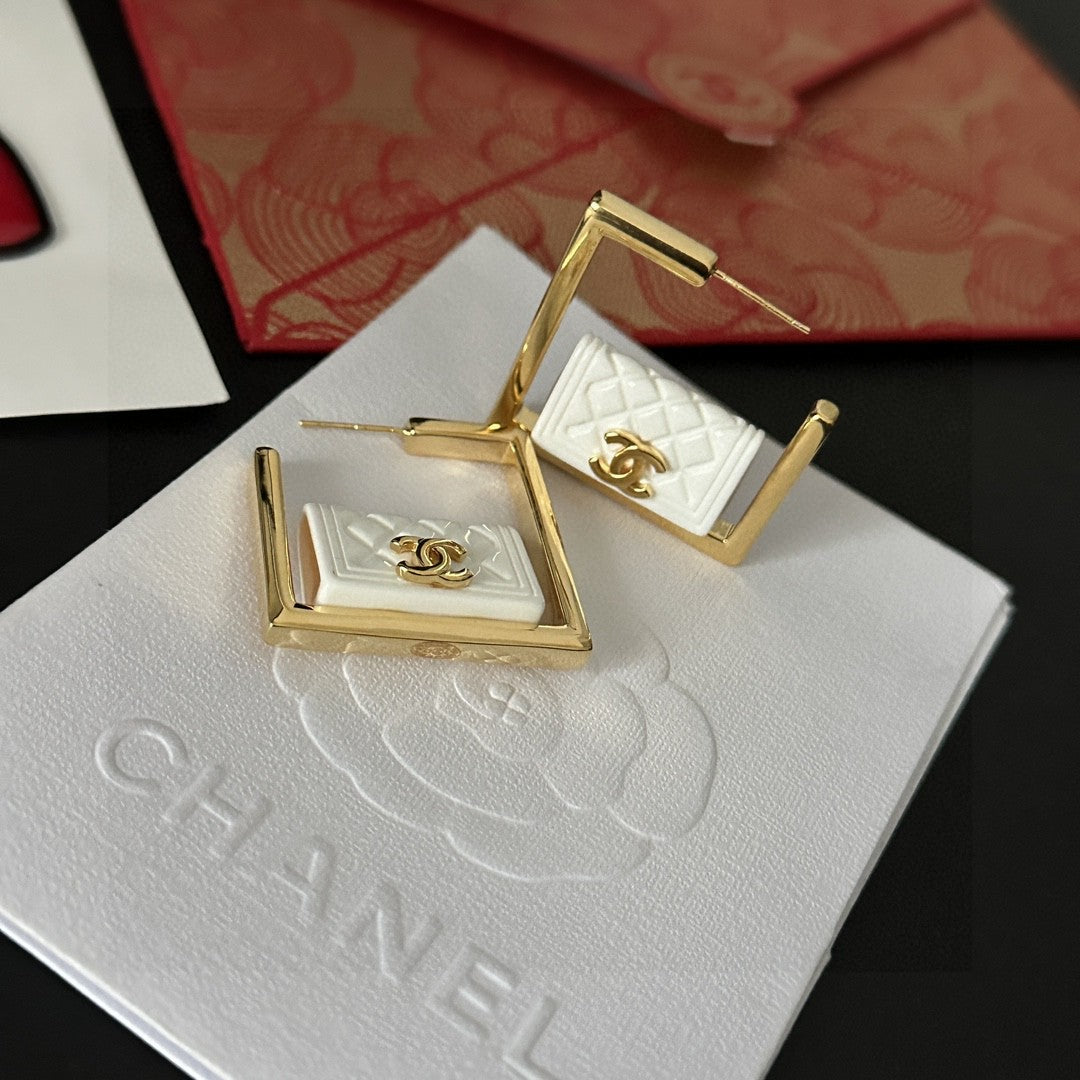 Double-C Emblem Stud Earrings in Polished Metal-Tone – Design 111 detail view