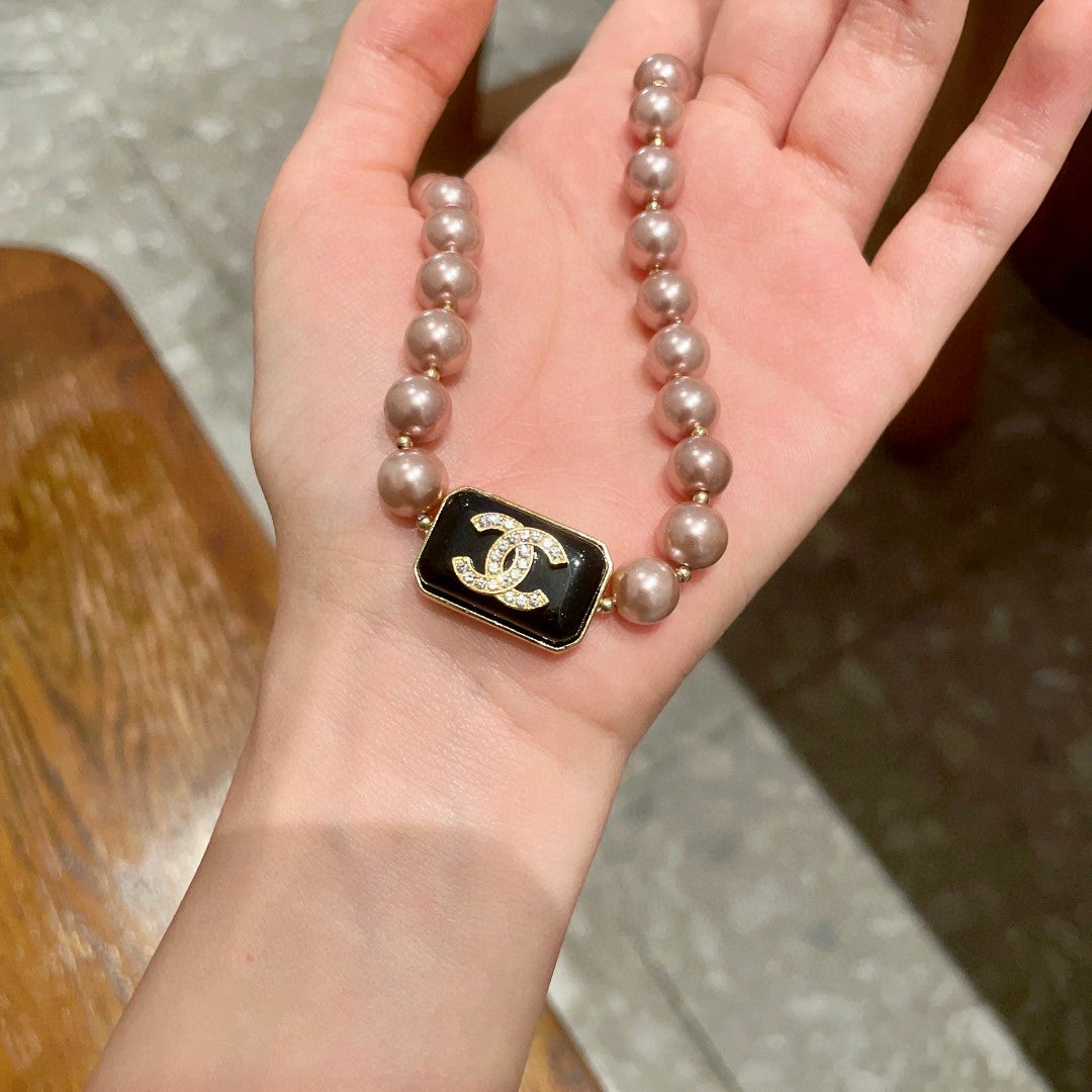 Double-C Emblem Pearl-Detail Pendant Necklace – Pearl Detail – Design 101 side detail