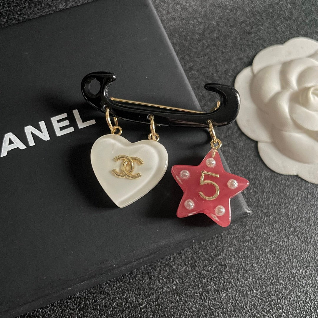 Double-C Emblem Brooch in Polished Metal-Tone – Star Detail detail view