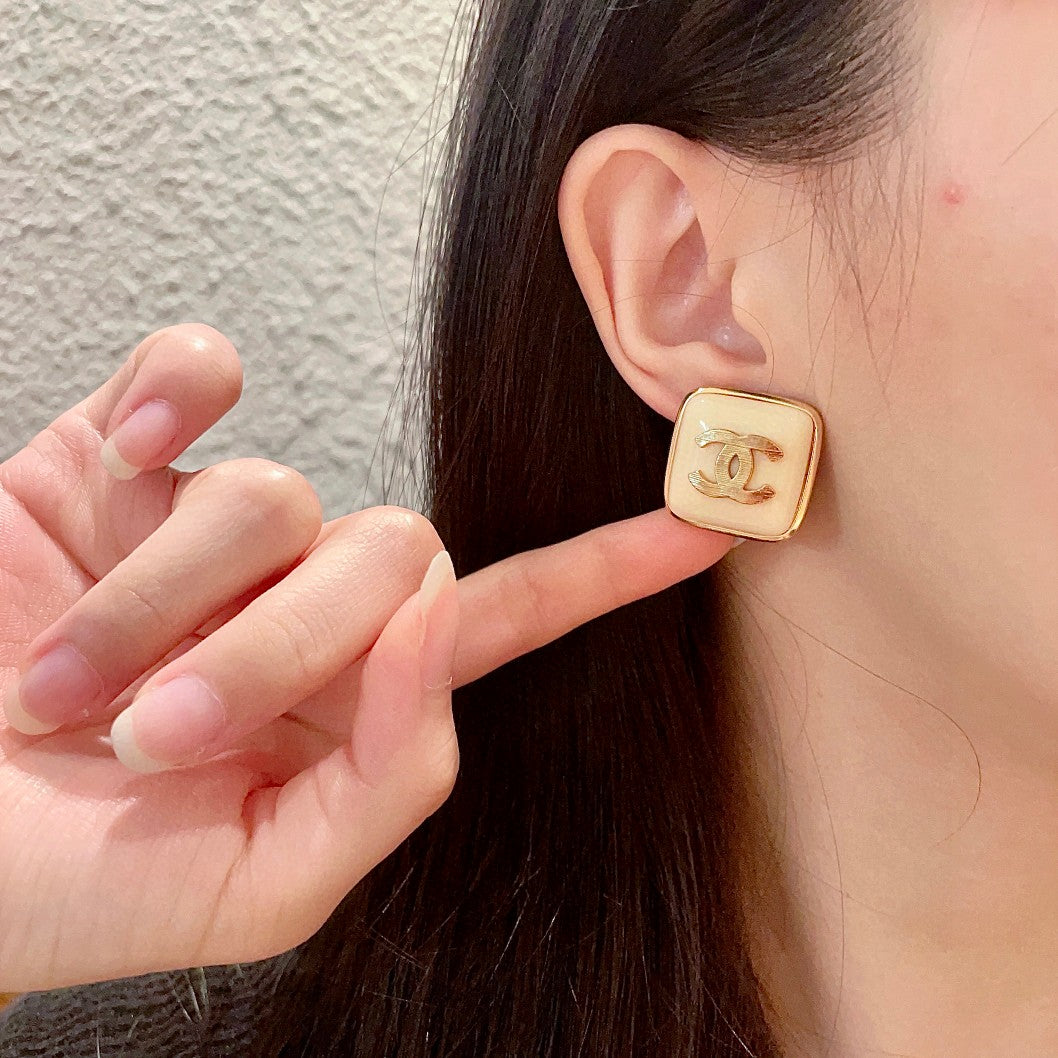 Double-C Emblem Stud Earrings in Polished Metal-Tone – Design 294 front product view