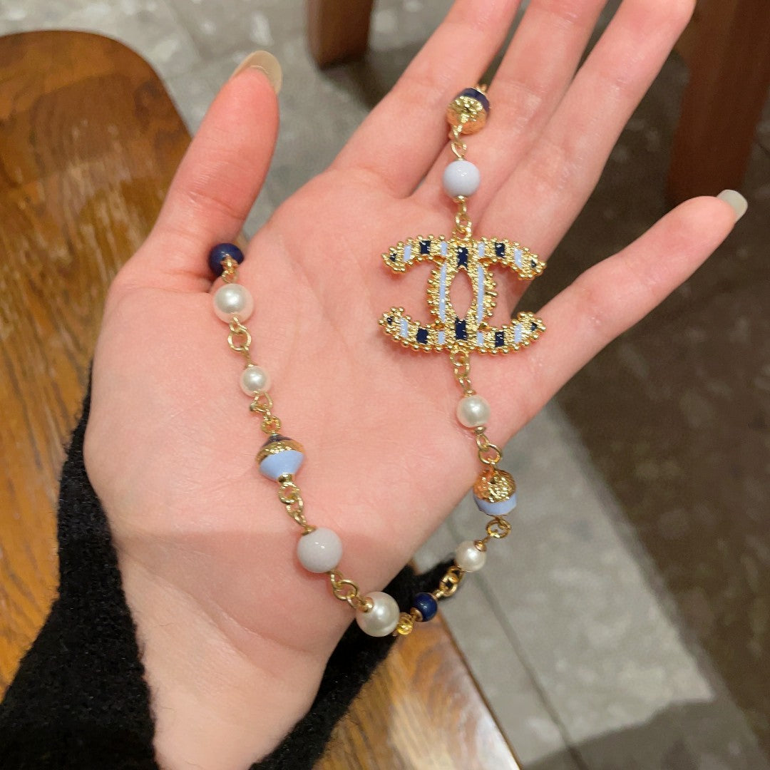 Double-C Emblem Pearl-Detail Pendant Necklace – Pearl Detail – Design 011 styled product view