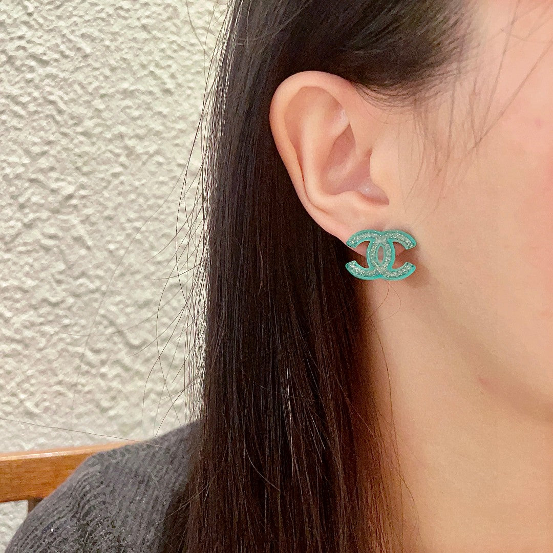 Double-C Emblem Stud Earrings in Polished Metal-Tone – Design 469 detail view