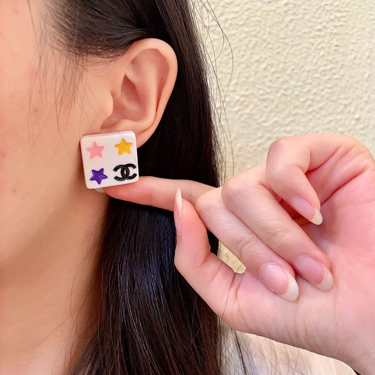 Double-C Emblem Stud Earrings in Polished Metal-Tone – Star Detail front product view