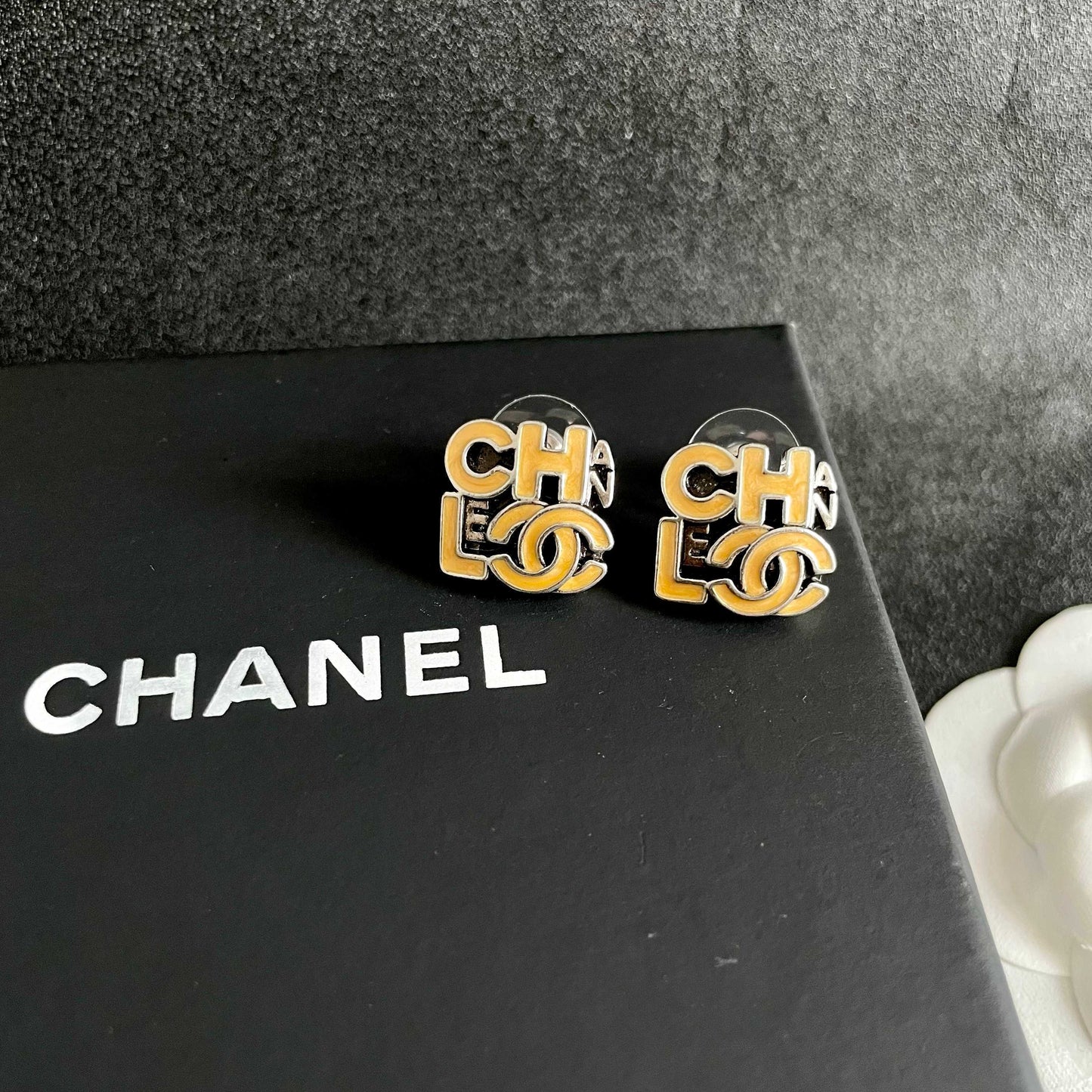 Double-C Emblem Stud Earrings in Polished Metal-Tone – Design 212 detail view