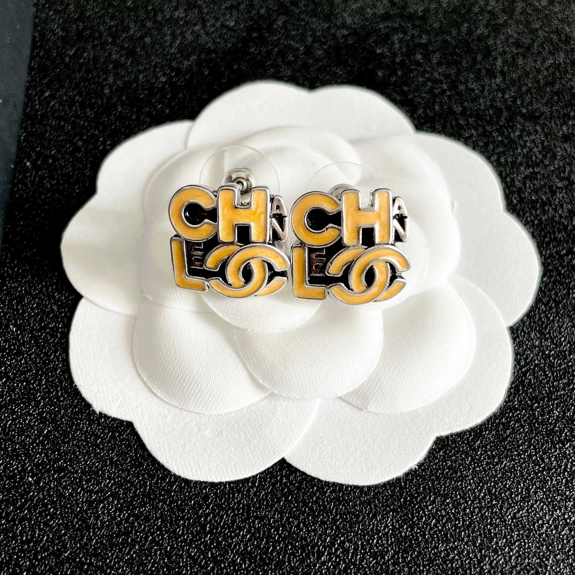 Double-C Emblem Stud Earrings in Polished Metal-Tone – Design 212 front product view