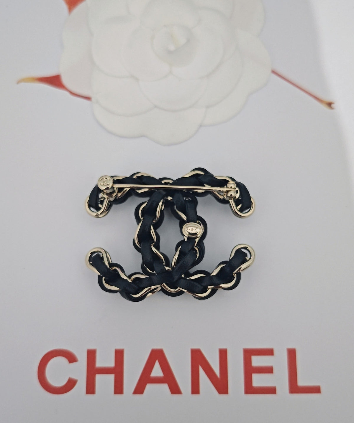 Signature Emblem Brooch in Gold-Tone – Black Detail close-up detail