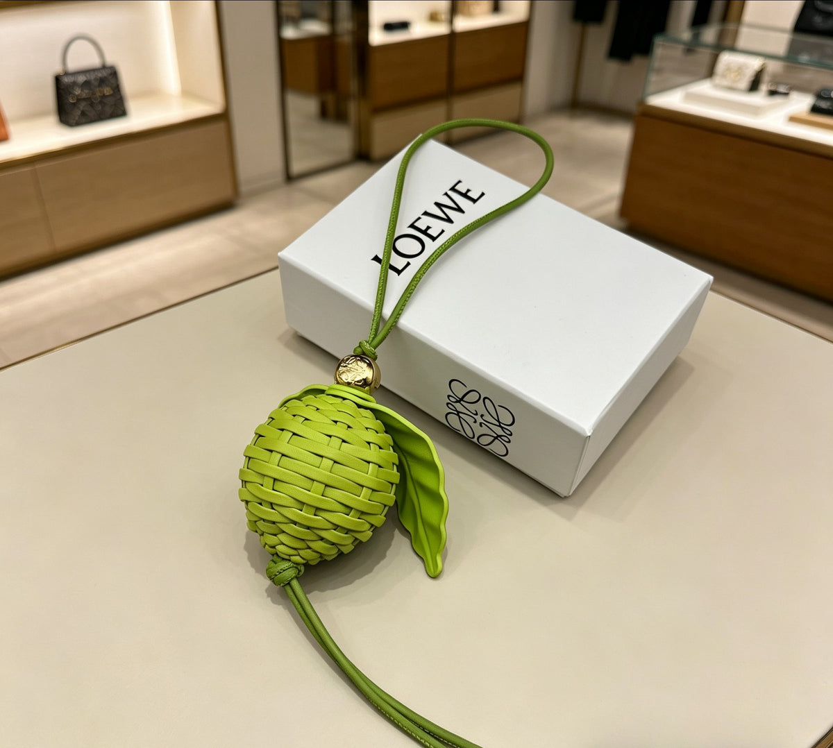 Leaf Motif Bag Charm in Polished Metal-Tone with Leather Detail front view