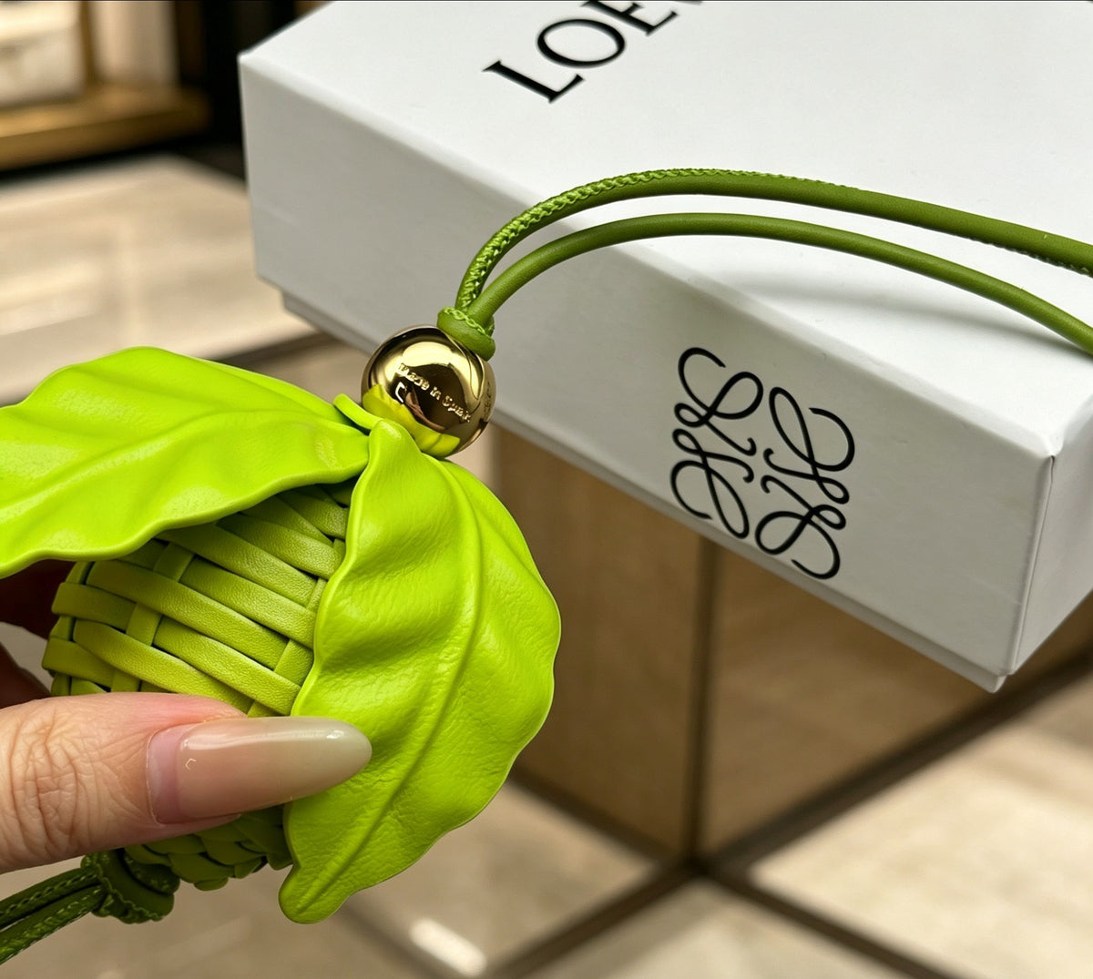 Leaf Motif Bag Charm in Polished Metal-Tone with Leather Detail styled view