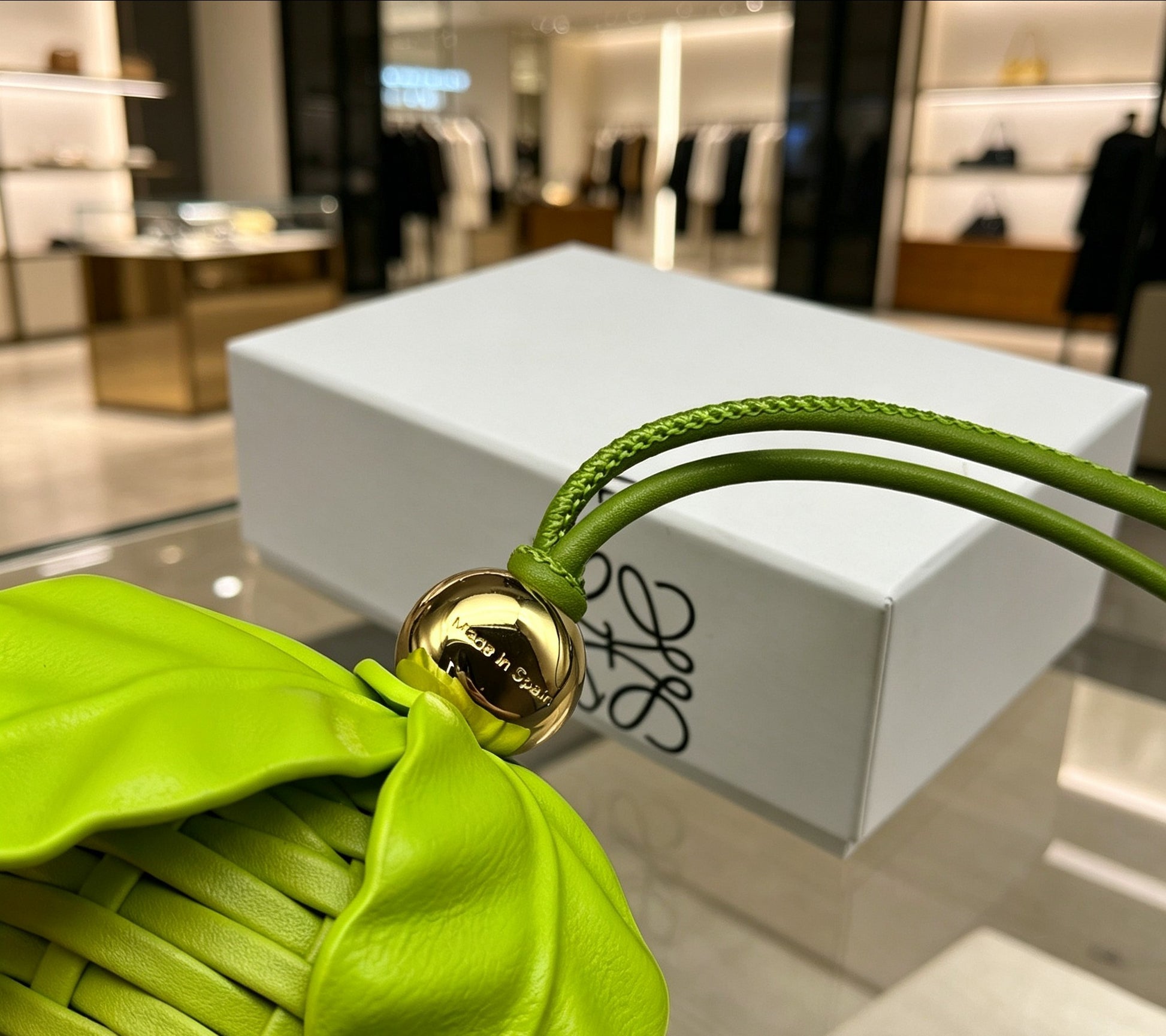 Leaf Motif Bag Charm in Polished Metal-Tone with Leather Detail close-up detail