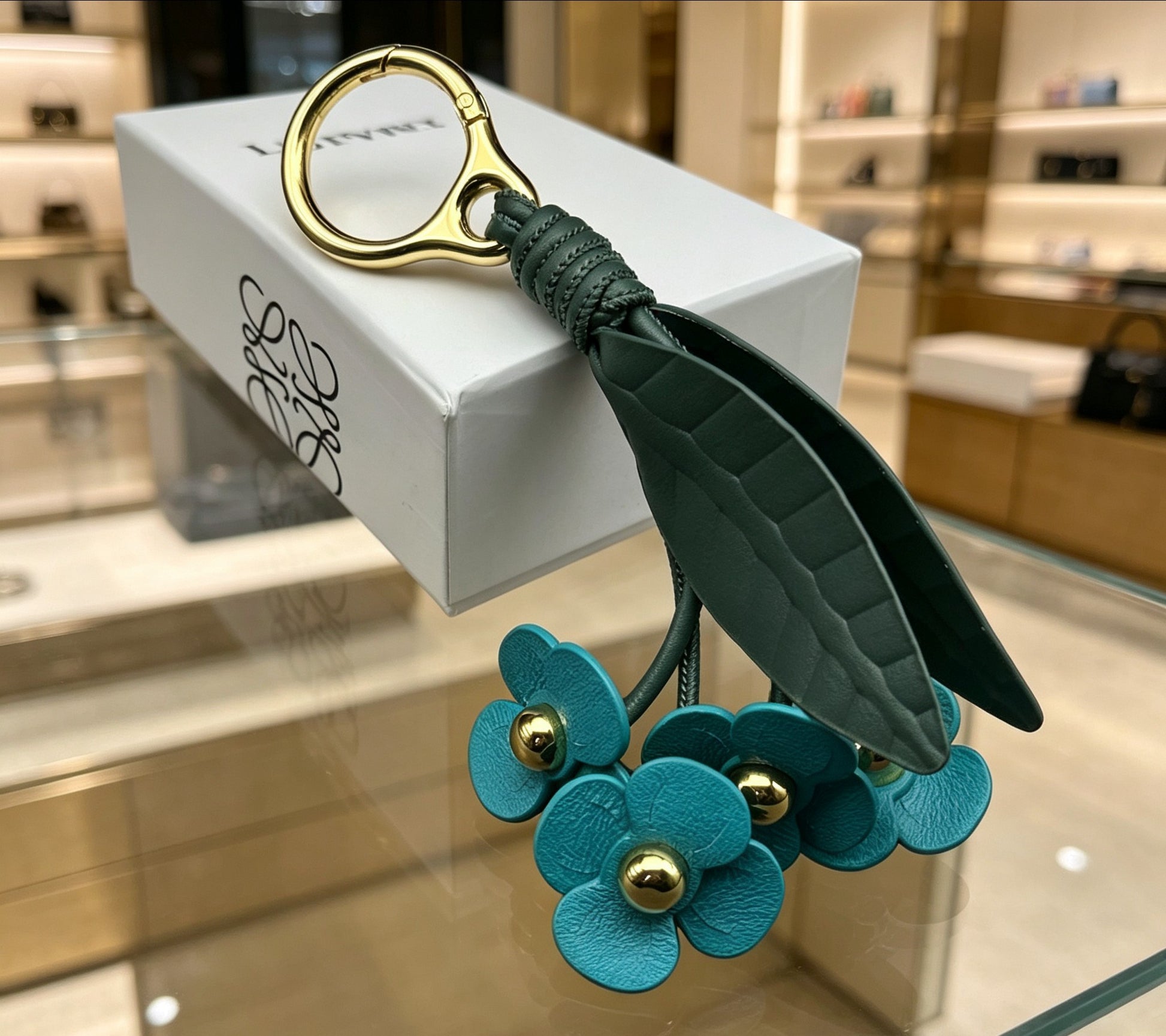 Floral Motif Bag Charm in Polished Metal-Tone with Leather Detail – Design 02 front view