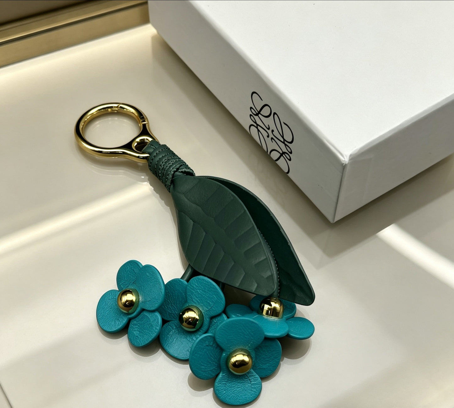 Floral Motif Bag Charm in Polished Metal-Tone with Leather Detail – Design 02 detail view