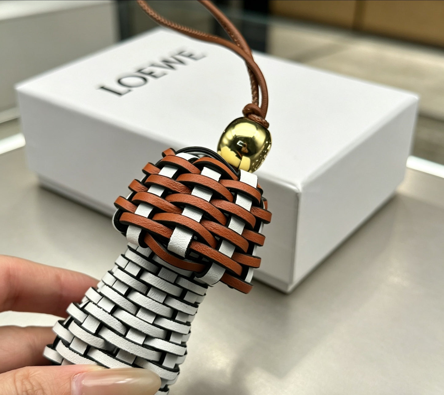 Graphic Emblem Bag Charm in Polished Metal-Tone with Leather Detail – Design 01 front view