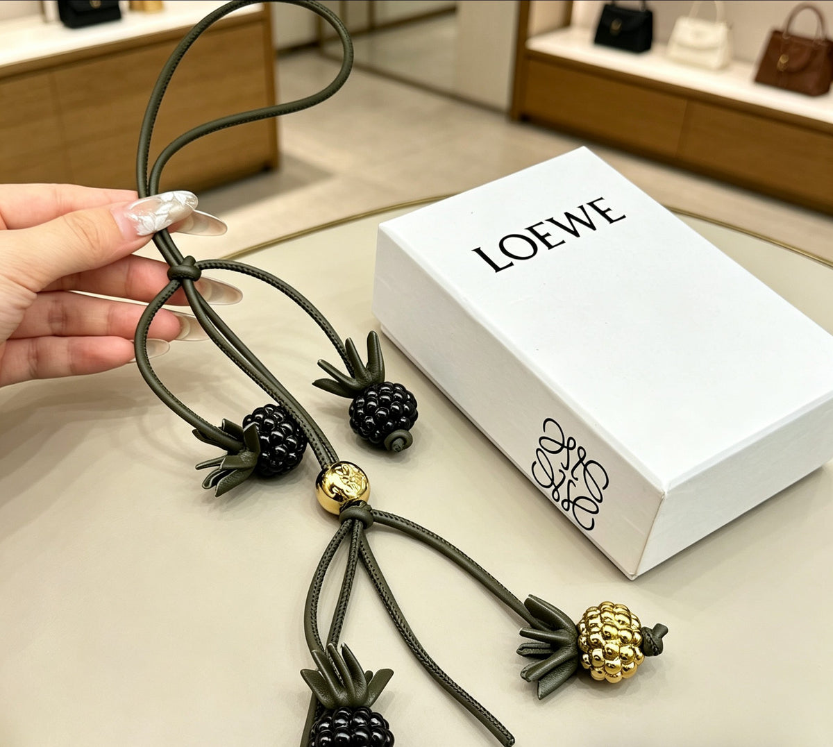Graphic Emblem Bag Charm in Polished Metal-Tone with Leather Detail – Design 02 detail view