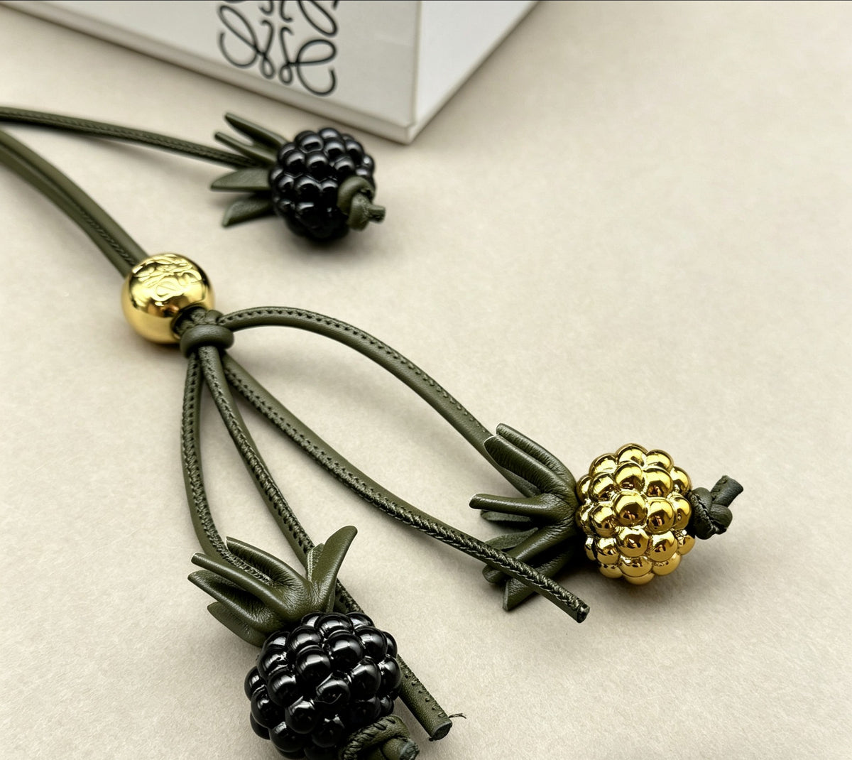 Graphic Emblem Bag Charm in Polished Metal-Tone with Leather Detail – Design 02 styled view