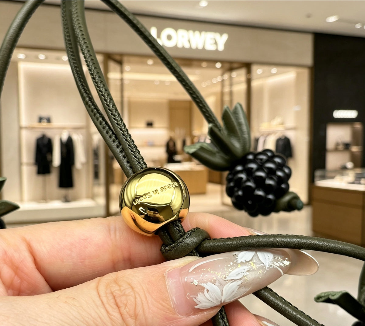 Graphic Emblem Bag Charm in Polished Metal-Tone with Leather Detail – Design 02 close-up detail