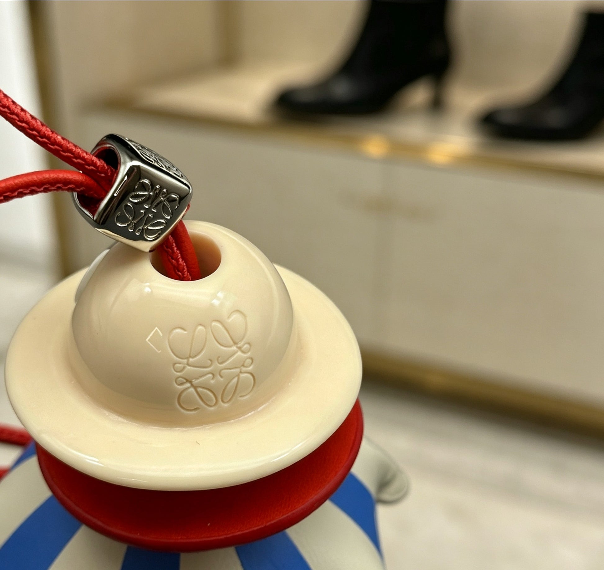 Graphic Emblem Bag Charm in Polished Metal-Tone with Leather Detail – Design 04 close-up detail