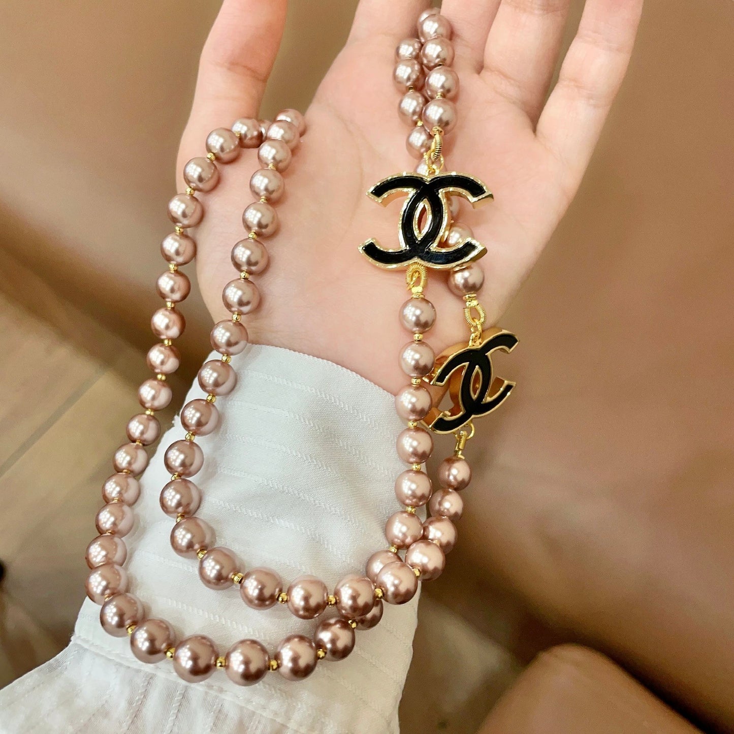Double-C Emblem Jewelry Accessory in Gold-Tone – Pearl Detail side detail