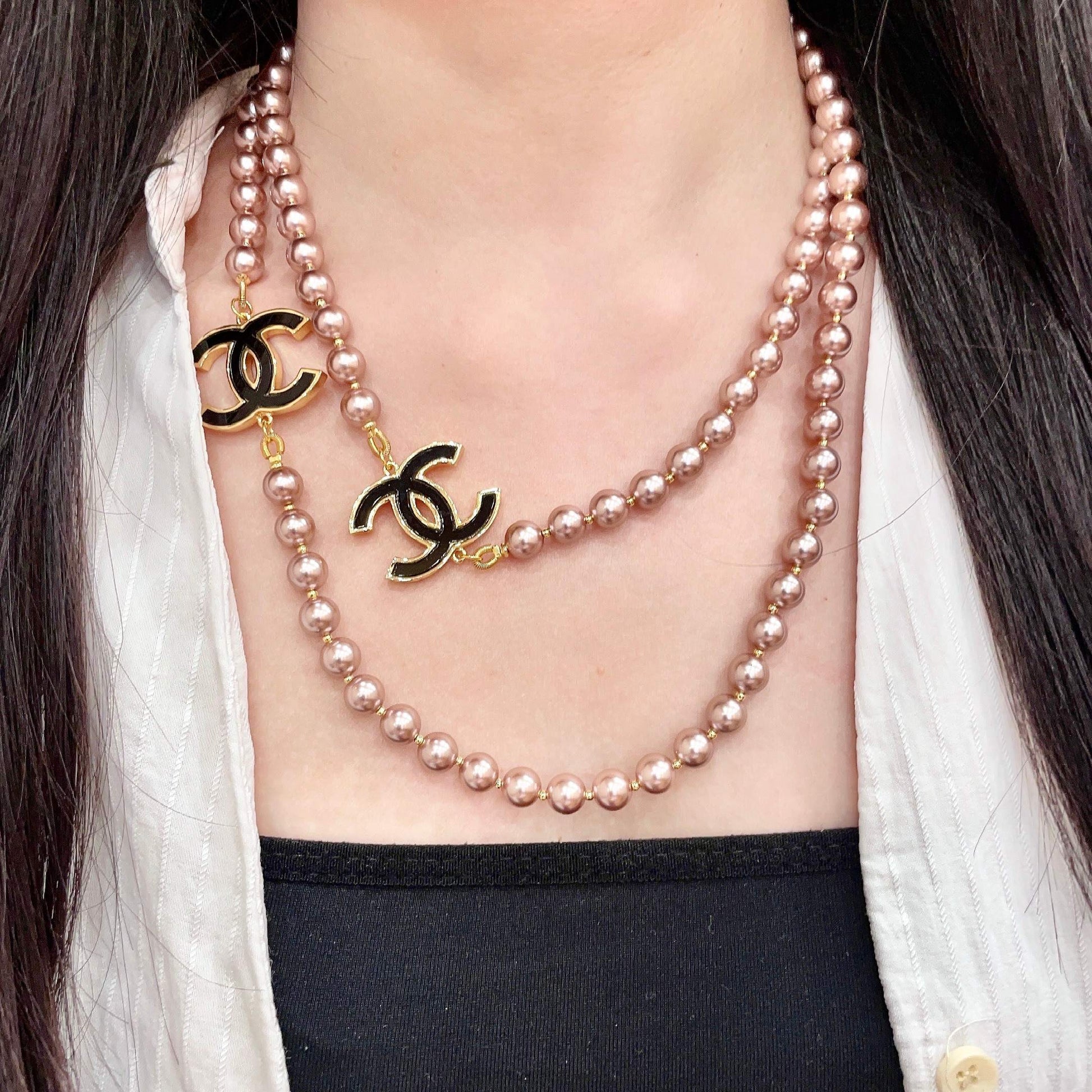Double-C Emblem Jewelry Accessory in Gold-Tone – Pearl Detail detail view