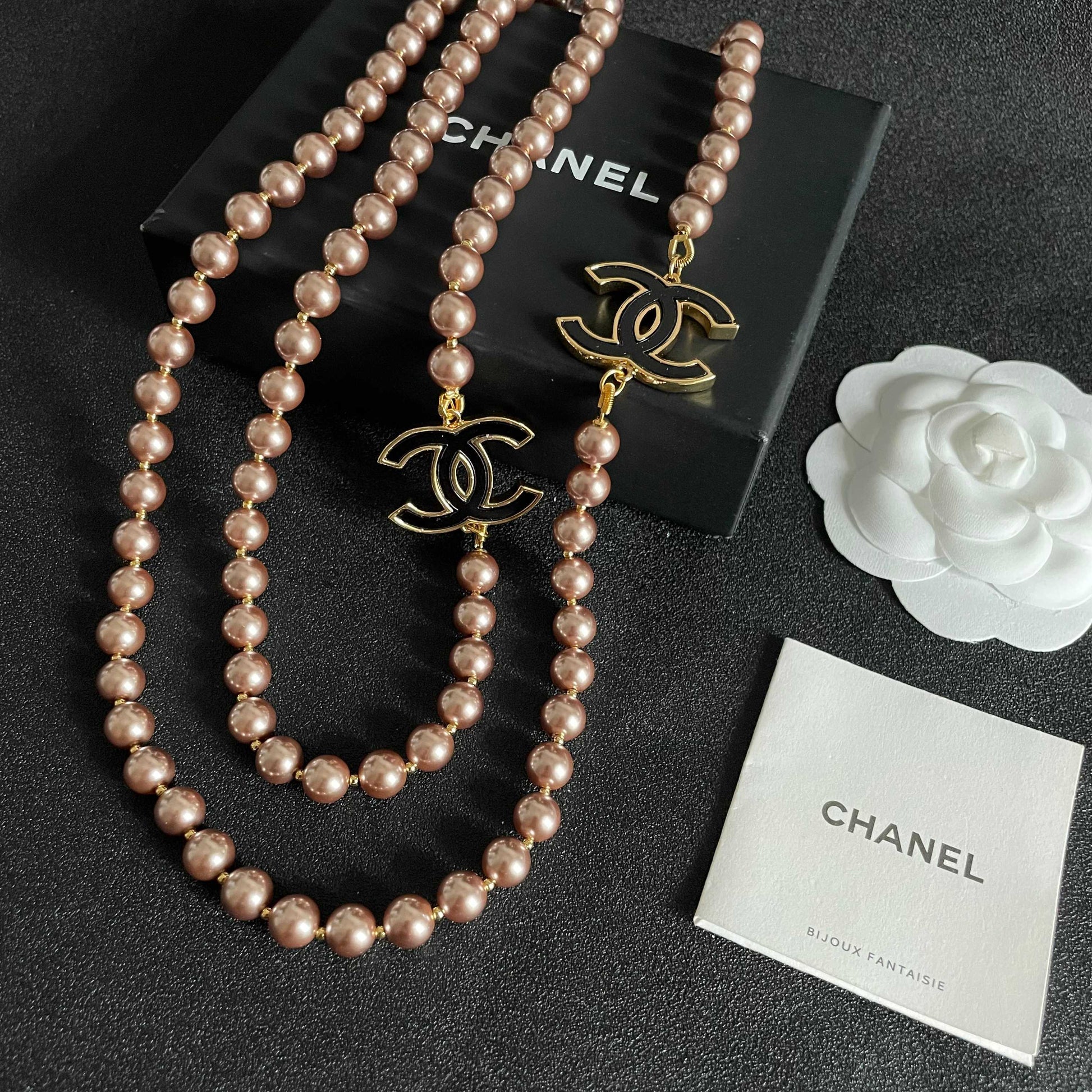 Double-C Emblem Jewelry Accessory in Gold-Tone – Pearl Detail close-up detail