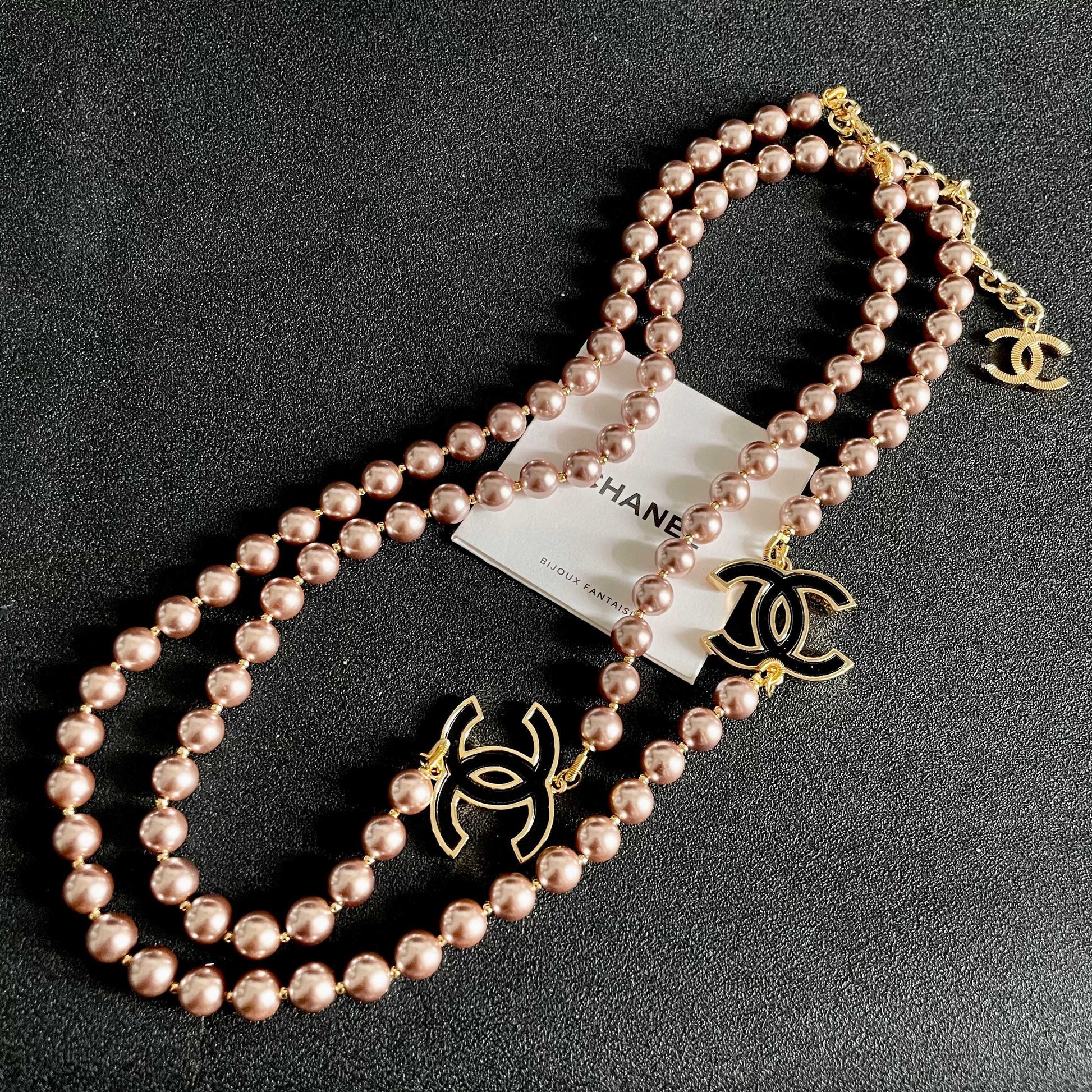 Double-C Emblem Jewelry Accessory in Gold-Tone – Pearl Detail detail view