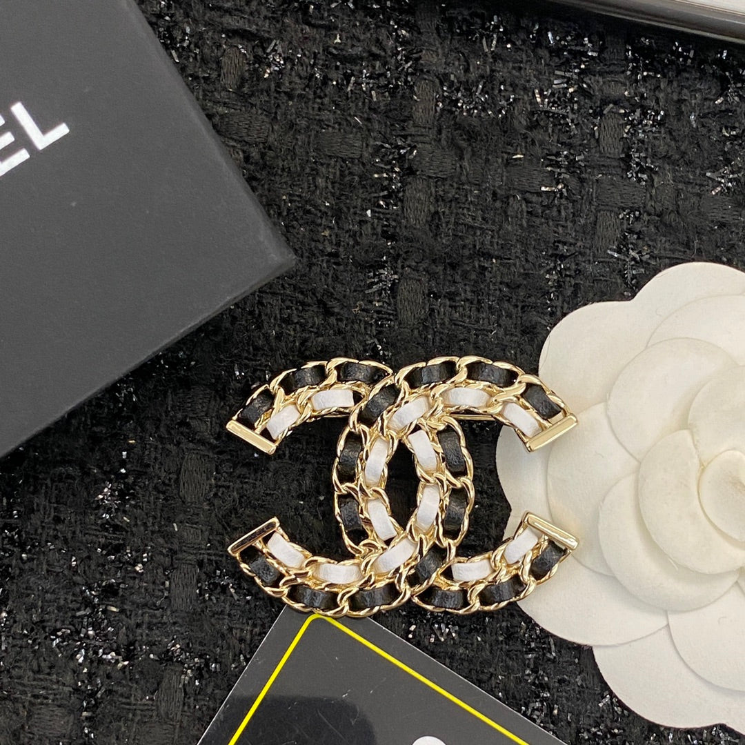 Signature Emblem Brooch in Polished Metal-Tone – Black Detail front product view