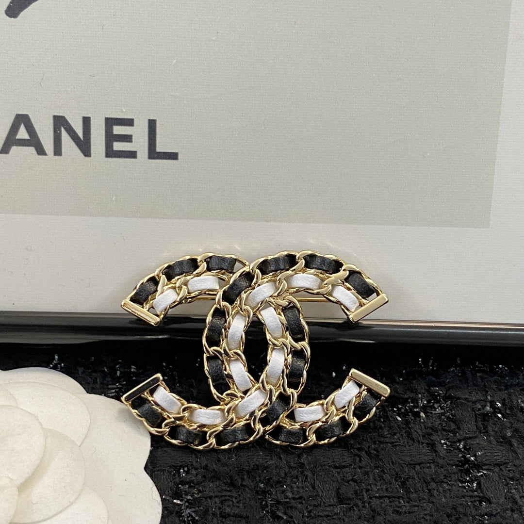 Signature Emblem Brooch in Polished Metal-Tone – Black Detail detail view
