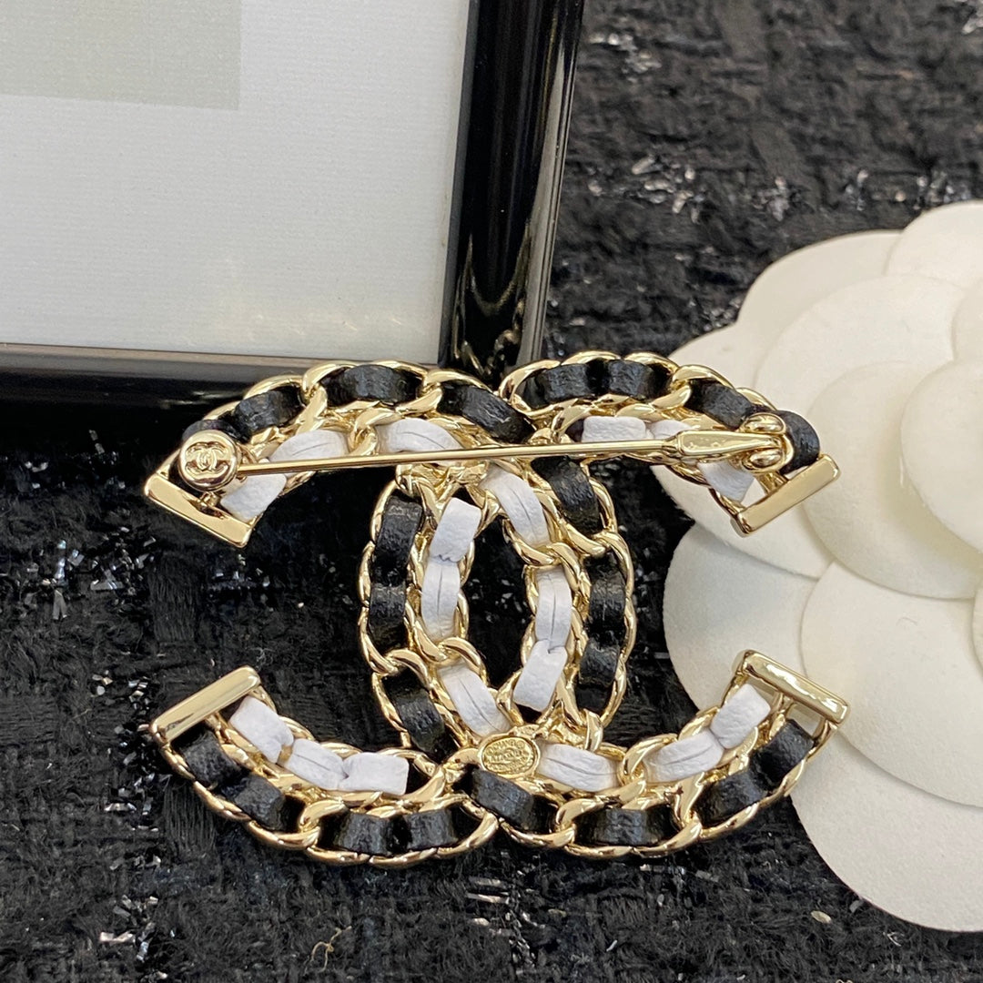 Signature Emblem Brooch in Polished Metal-Tone – Black Detail styled product view