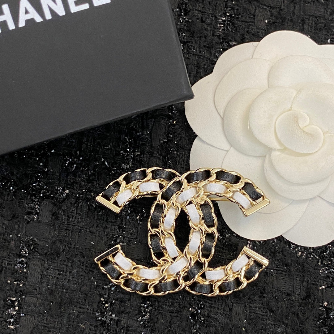 Signature Emblem Brooch in Polished Metal-Tone – Black Detail close-up detail