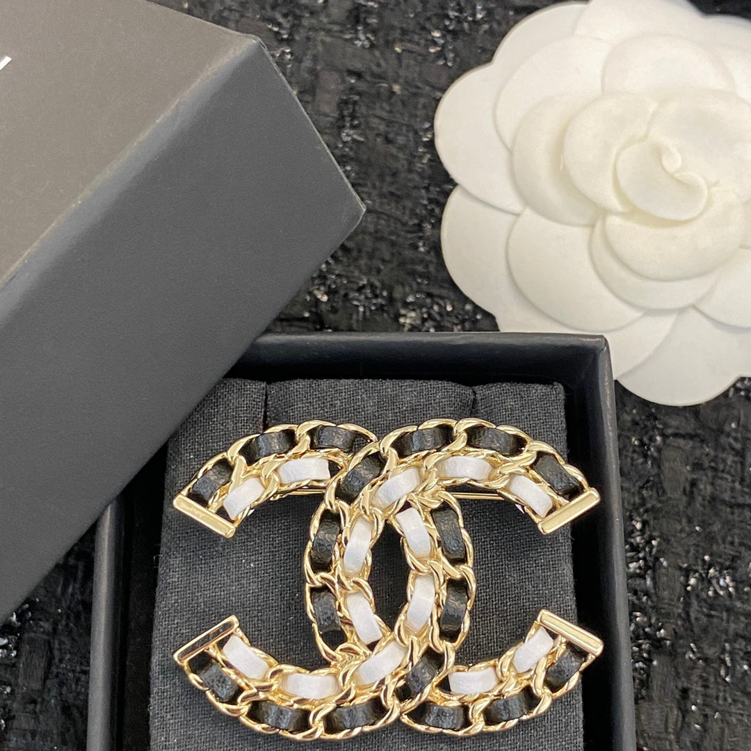 Signature Emblem Brooch in Polished Metal-Tone – Black Detail side detail