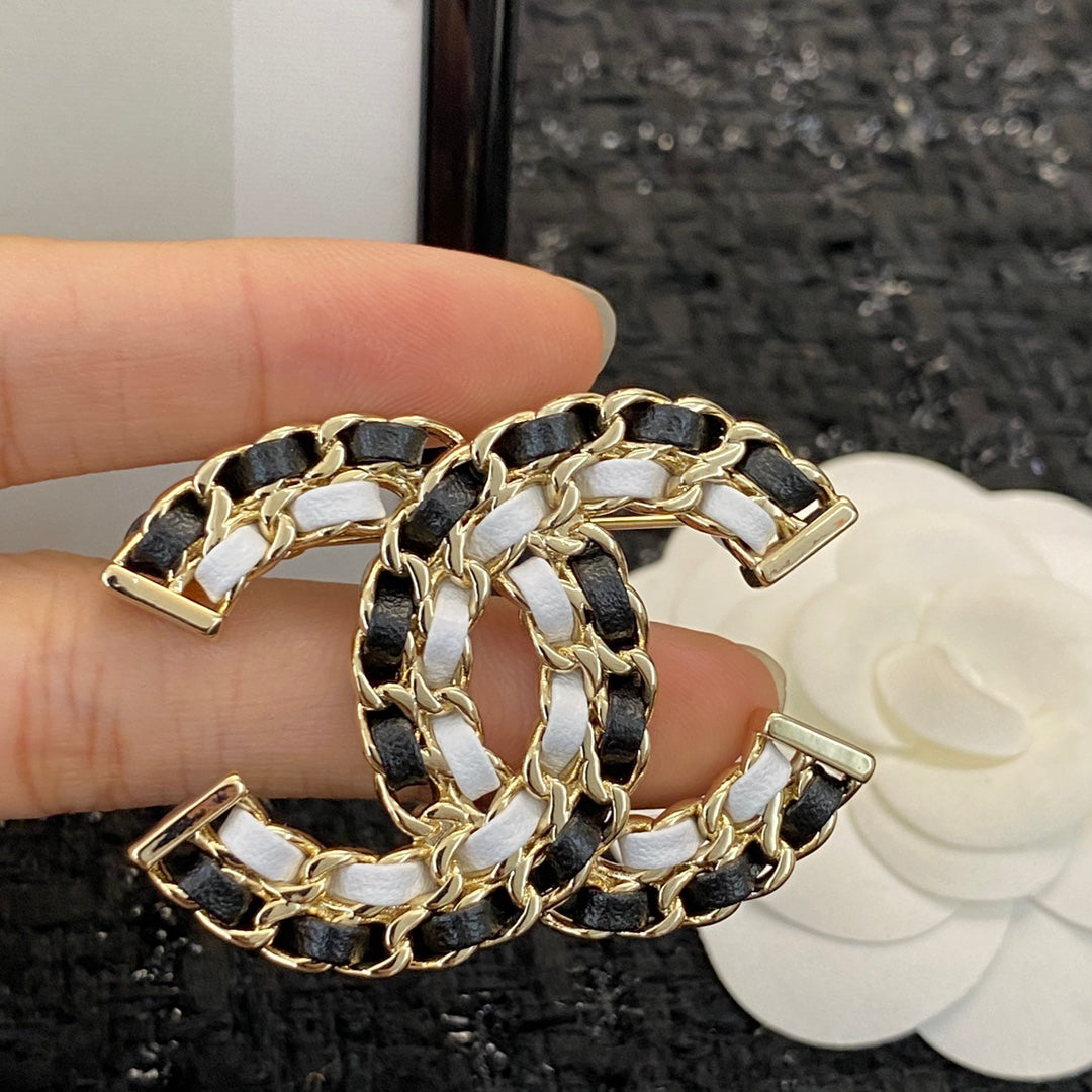 Signature Emblem Brooch in Polished Metal-Tone – Black Detail main product view