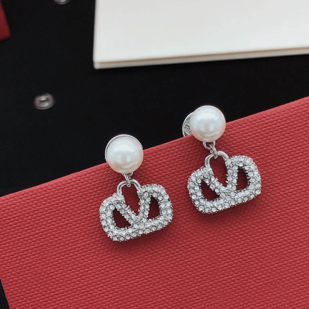 Signature Emblem Pearl-Detail Stud Earrings – Design 05 detail view