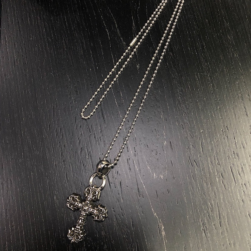 Cross Pendant Necklace in Metal-Tone – Flame Detail close-up detail