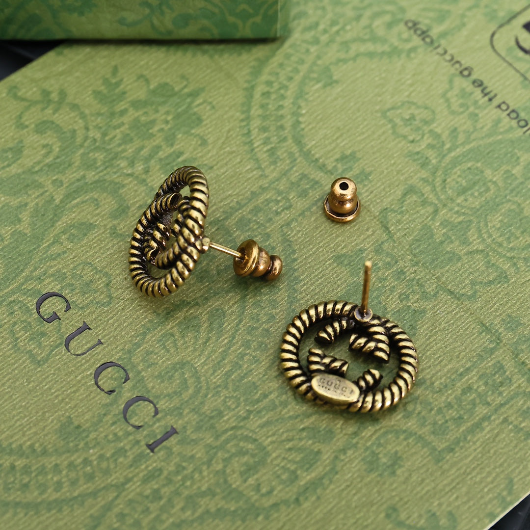 Serpentine Stud Earrings in Polished Metal-Tone close-up detail