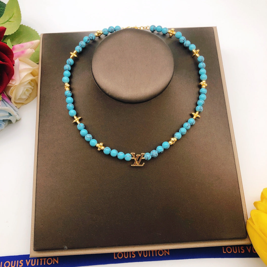Geometric Emblem Pendant Necklace in Gold-Tone – Blue Detail – Design 007 styled product view