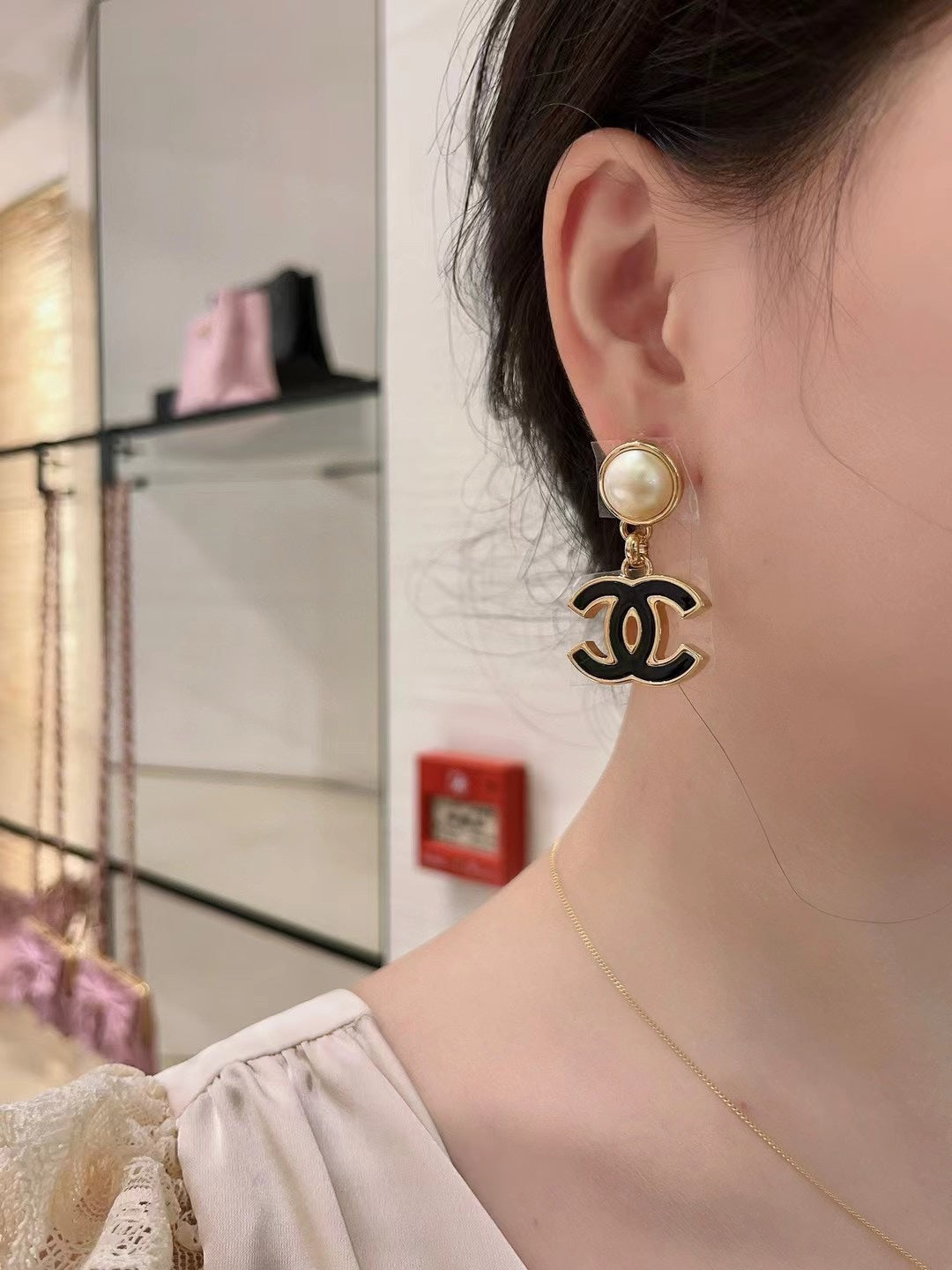 Double-C Emblem Stud Earrings in Black-Tone – Black Detail – Design 002 close-up detail