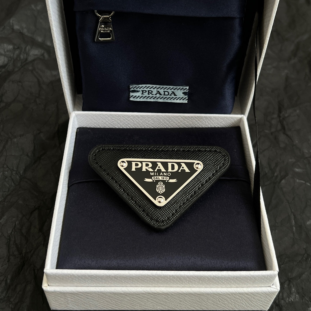Signature Emblem Brooch in Polished Metal-Tone front view