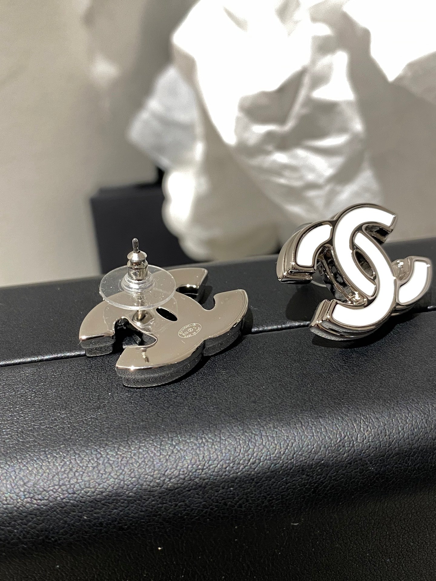 Double-C Emblem Stud Earrings in Polished Metal-Tone – White Detail – Design 004 detail view