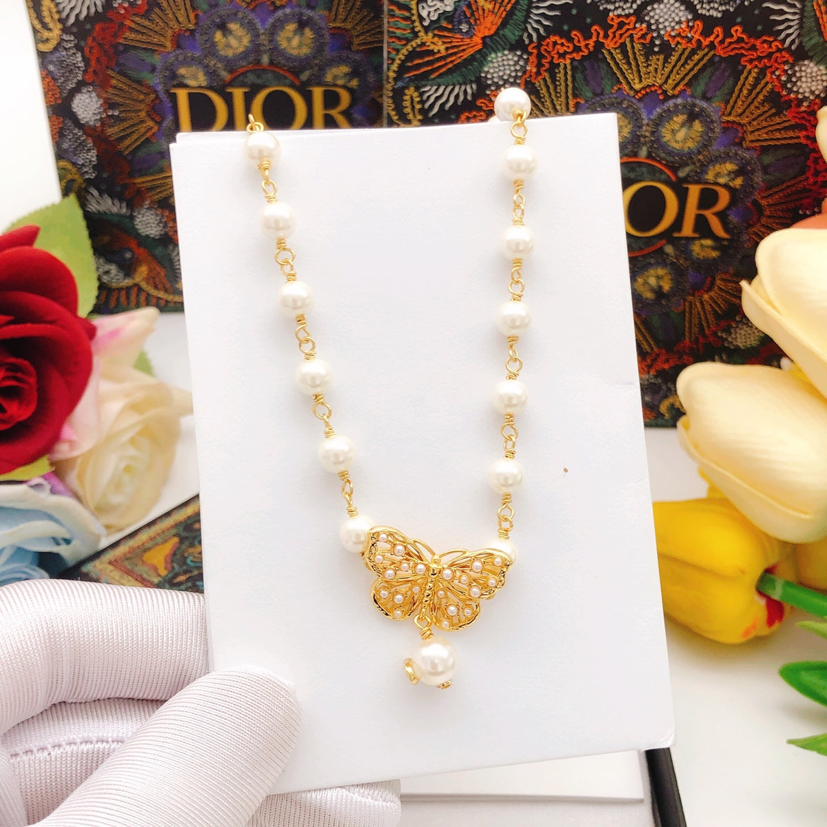 Bow & Butterfly Motif Pendant Necklace in Polished Metal-Tone with Pearl-Style Detail – Design 001 front view