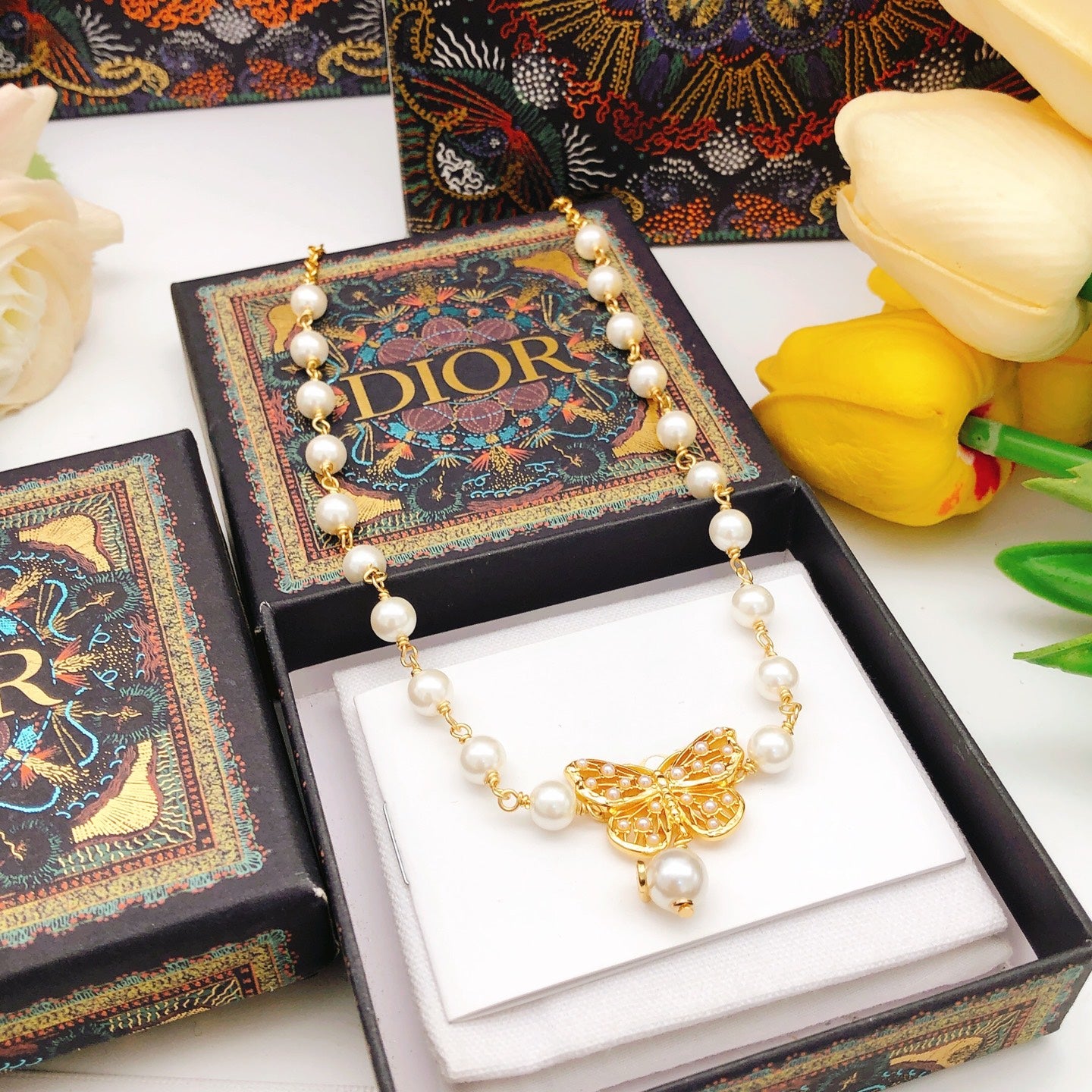Bow & Butterfly Motif Pendant Necklace in Polished Metal-Tone with Pearl-Style Detail – Design 001 detail view