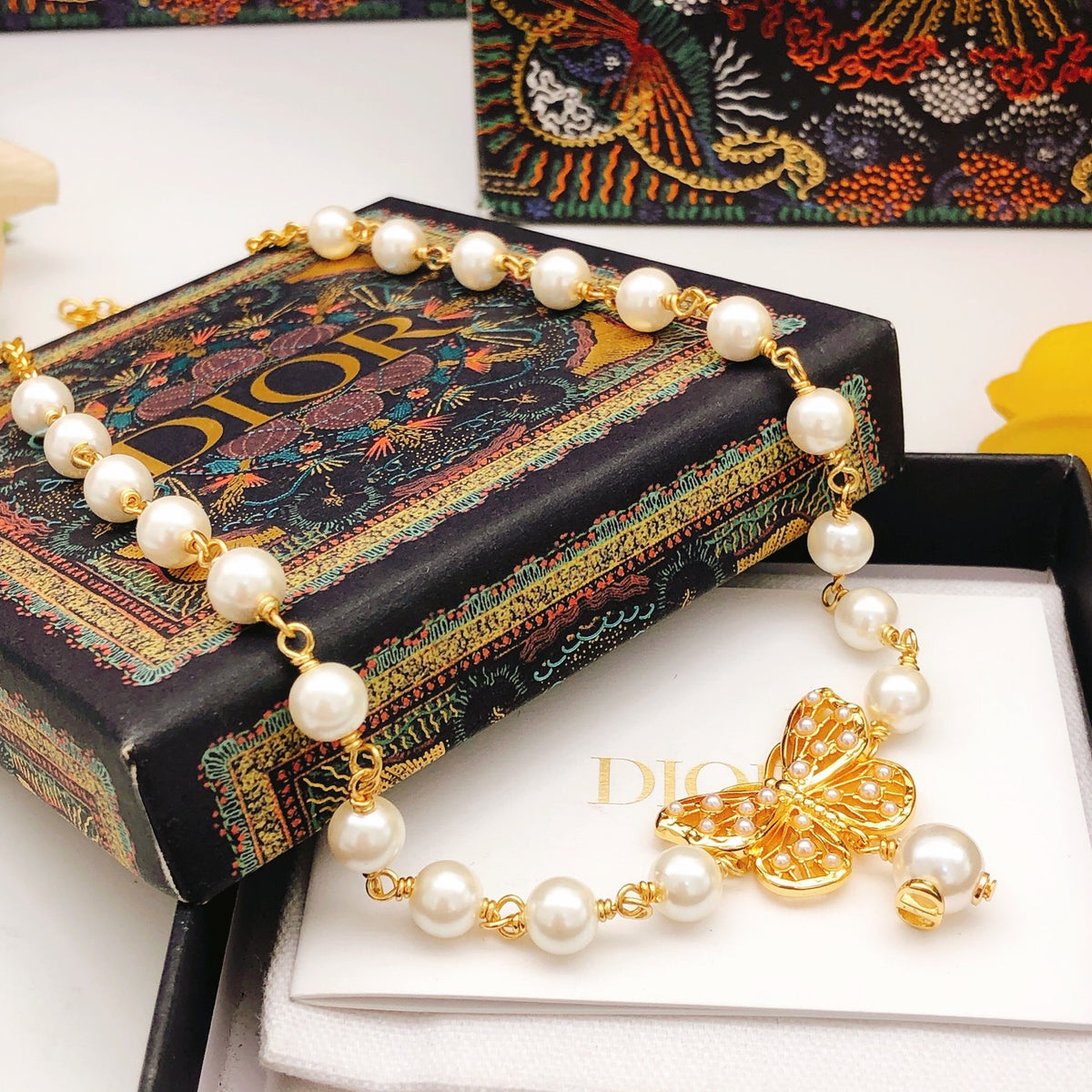 Bow & Butterfly Motif Pendant Necklace in Polished Metal-Tone with Pearl-Style Detail – Design 001 styled view