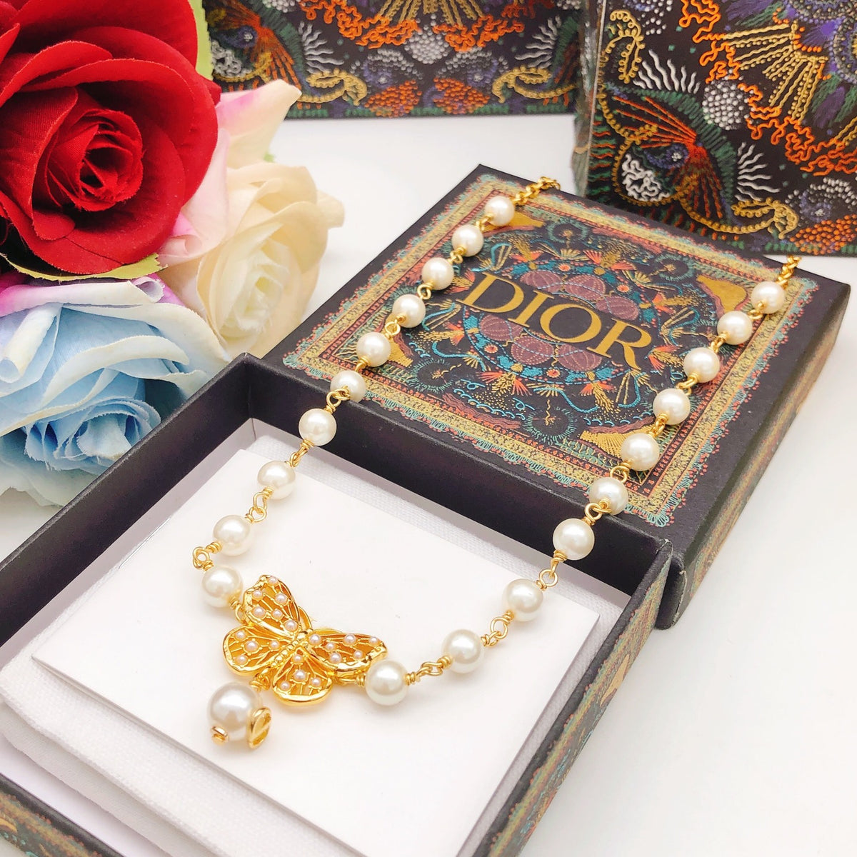 Bow & Butterfly Motif Pendant Necklace in Polished Metal-Tone with Pearl-Style Detail – Design 001 side detail