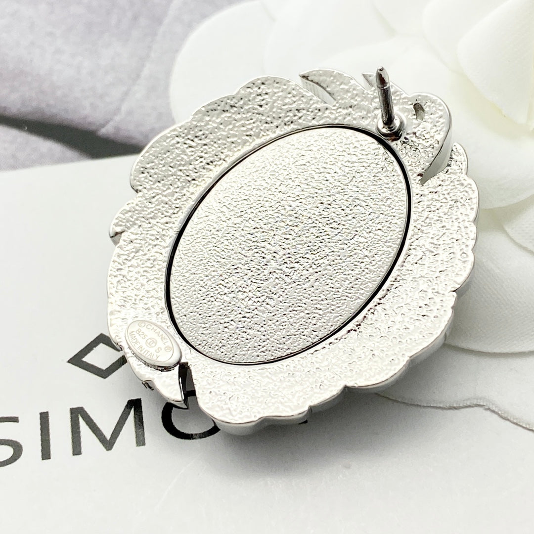 Signature Emblem Brooch in Black-Tone close-up detail