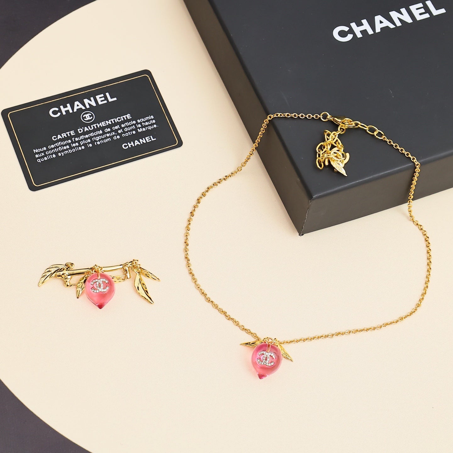 Signature Emblem Pendant Necklace in Polished Metal-Tone – Pink Detail front product view