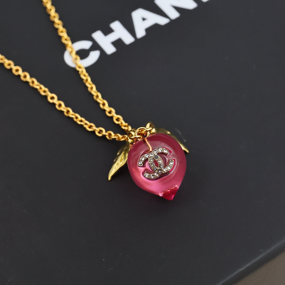 Signature Emblem Pendant Necklace in Polished Metal-Tone – Pink Detail close-up detail