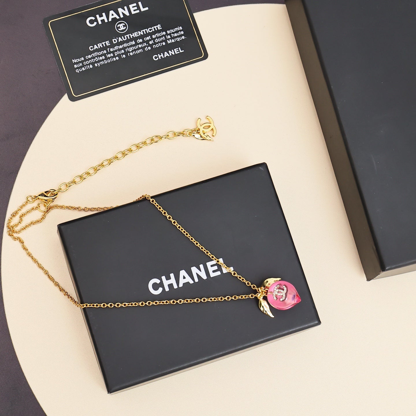 Signature Emblem Pendant Necklace in Polished Metal-Tone – Pink Detail styled product view