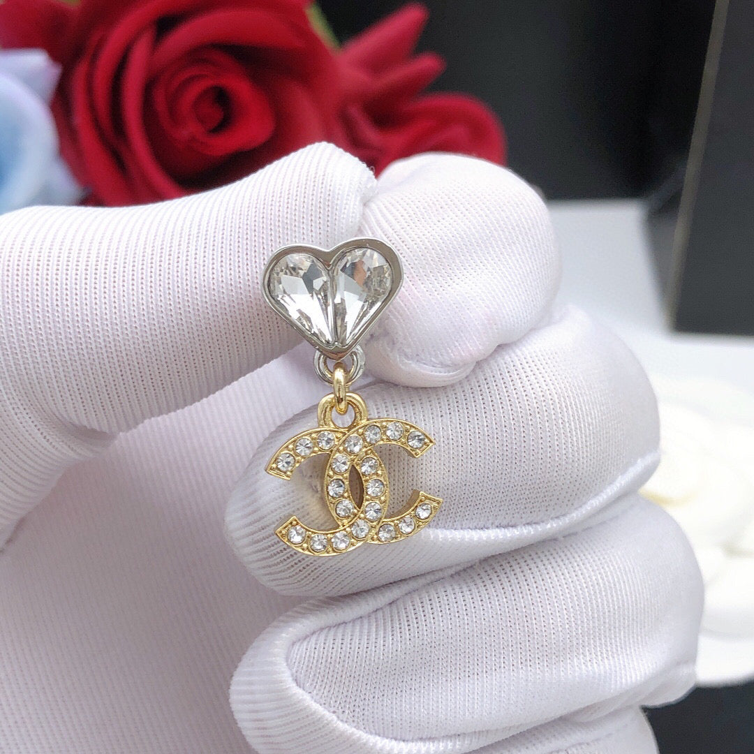 Double-C Emblem Jewelry Accessory in Gold-Tone – Heart Detail close-up detail