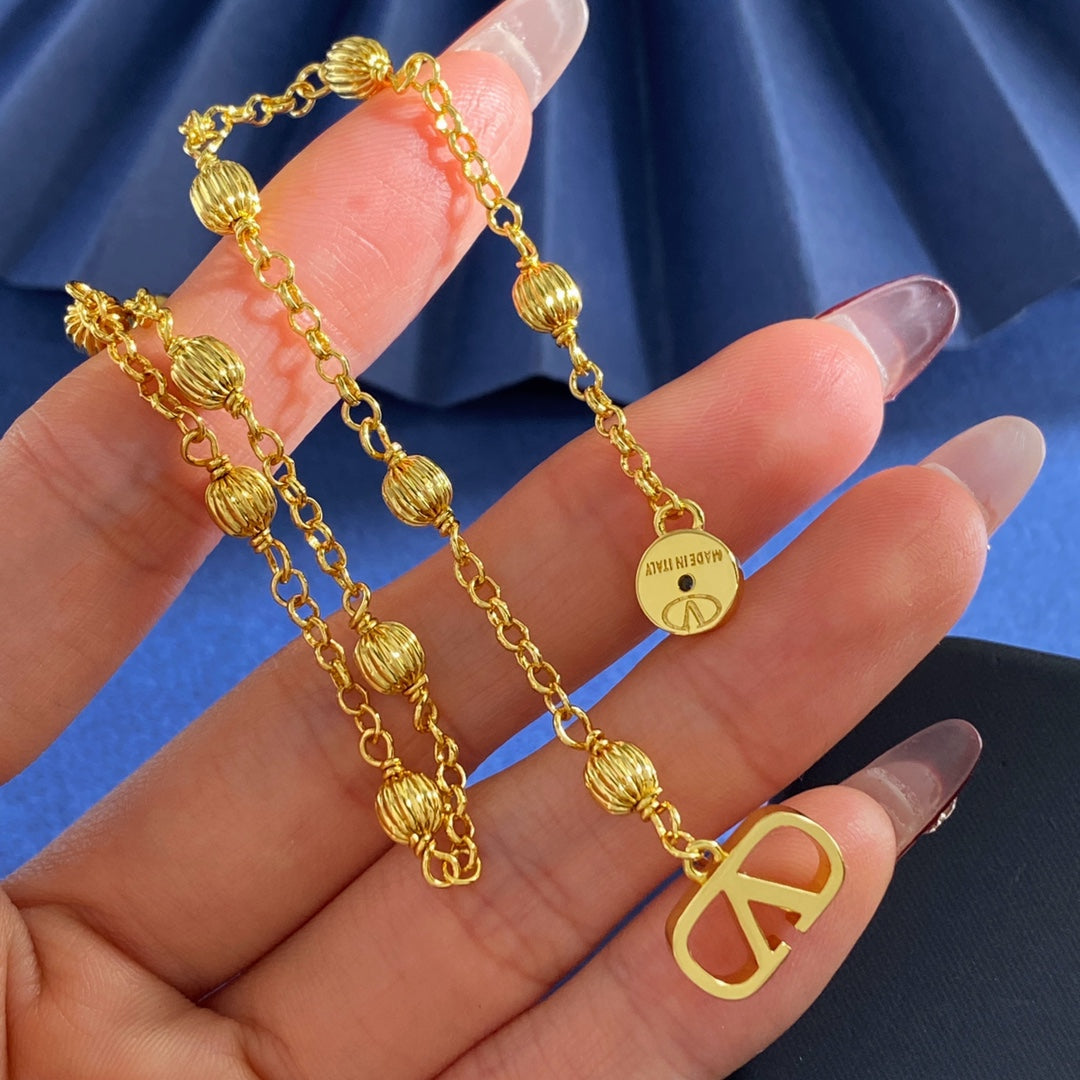 V Emblem Stud Earrings in Gold-Tone styled detail