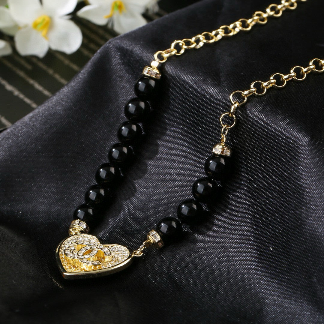 Double-C Emblem Pendant Necklace in Gold-Tone – Heart Detail main product view