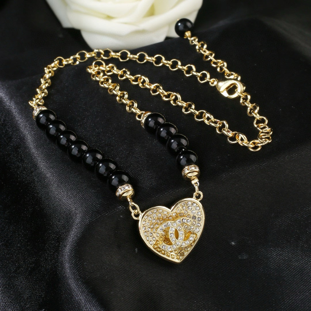 Double-C Emblem Pendant Necklace in Gold-Tone – Heart Detail side detail